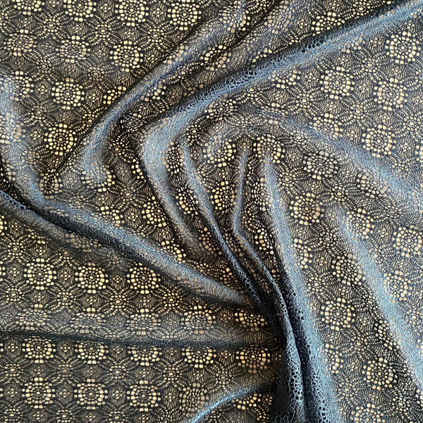 Tissu en dentelle maille extensible à motif de roue noire (145 cm de large) - 1 m