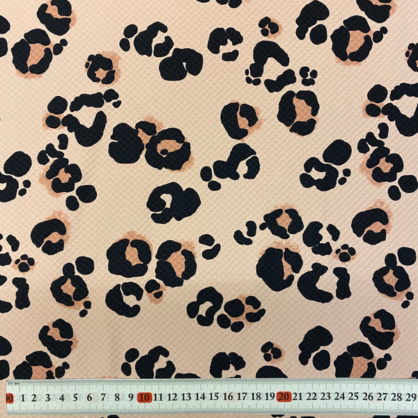 Tissu Lycra texturé gaufré léopard noir et beige - 1 m