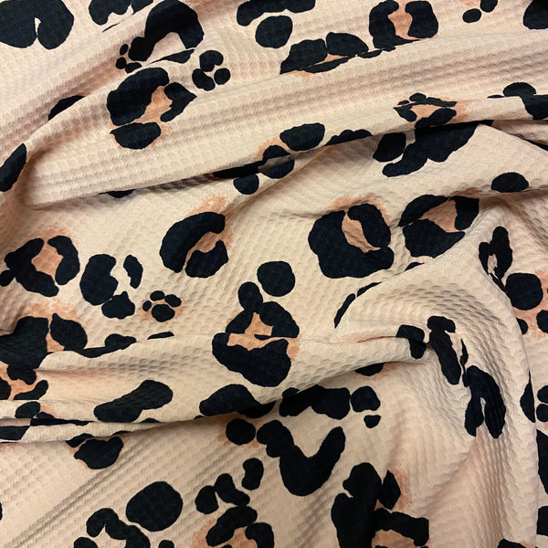 Tissu Lycra texturé gaufré léopard noir et beige - 1 m